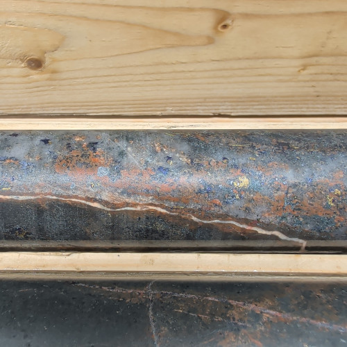 3.26% Cu, 0.647 g/t Au, 24.4 g/t Ag, 0.22% Mo from 339.8 m to 340.6 m